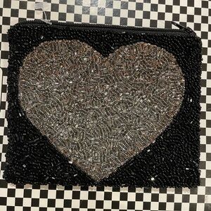 Moyna Black small pouch with silver heart. Top Zip . 5”w X 4 1/2w.